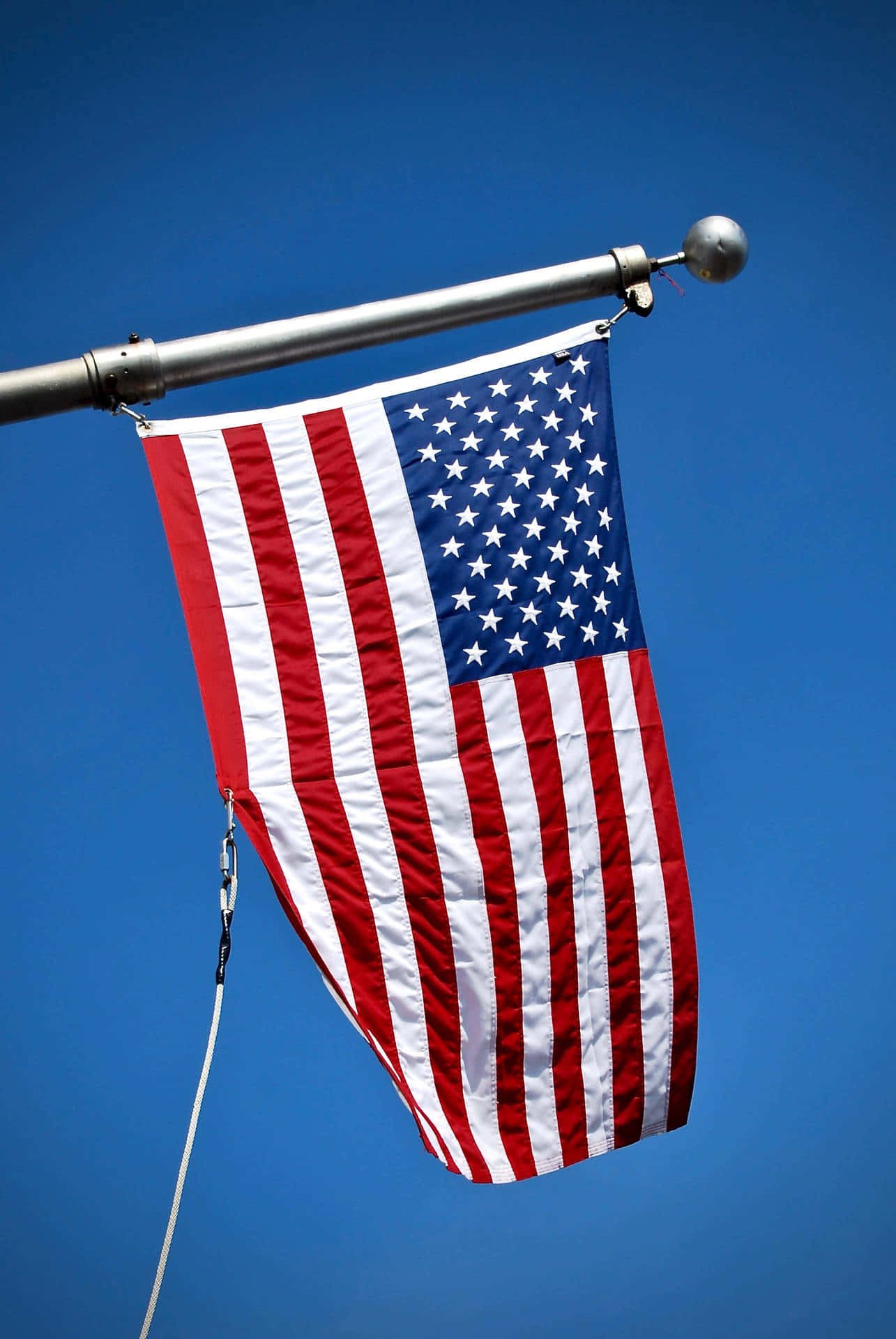 American Flag Against Blue Sky Wallpaper