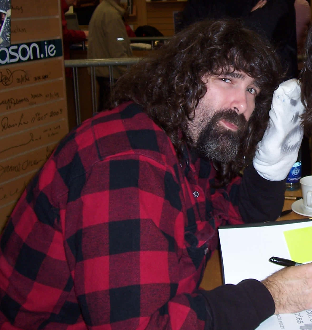 American Former Wrestler Mick Foley Engaging with Fans at a Book Signing Event Wallpaper