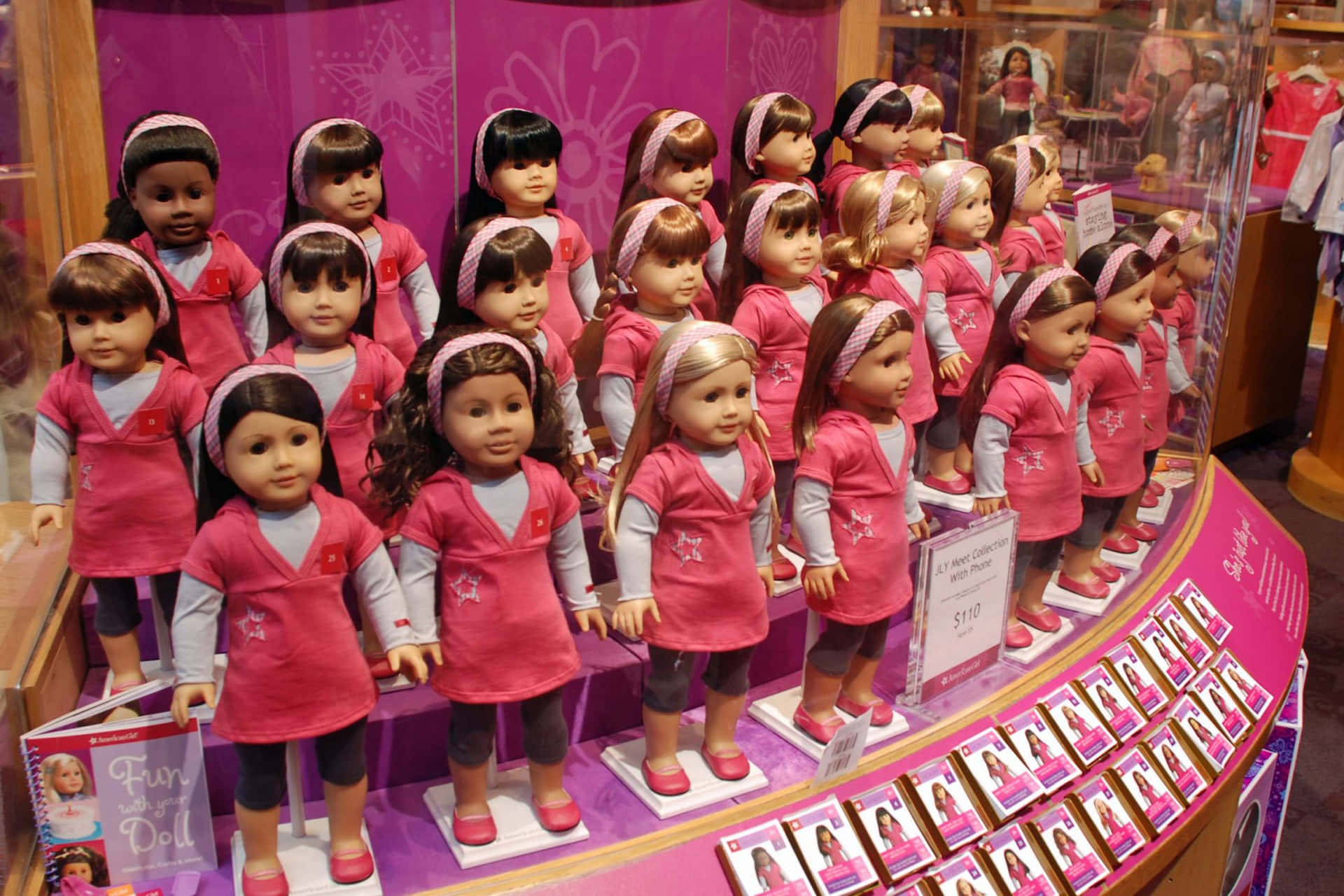 A Display Of American Girl Dolls In Pink