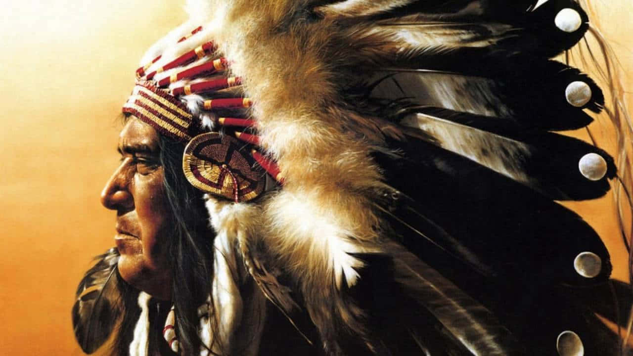 A Painting Of A Native American Man Wearing A Feathered Headdress
