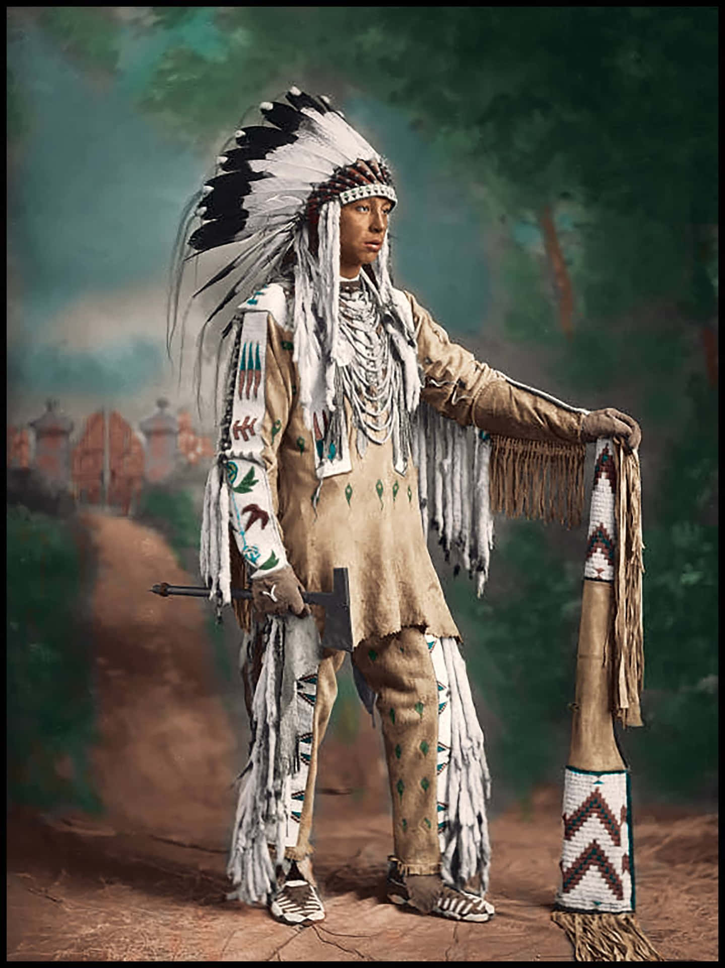 A Man In Native American Costume Holding An Axe