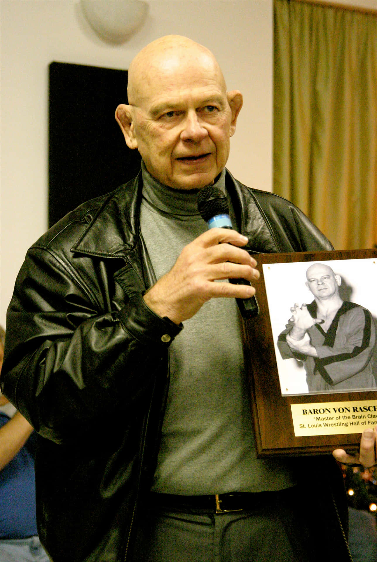 American Retired Wrestler Baron Von Raschke Holding His Memorabilia Portrait Wallpaper