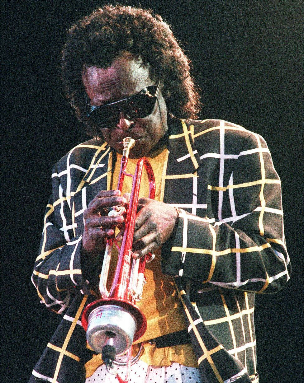 American Jazz Legend Miles Davis Playing Trumpet Wallpaper