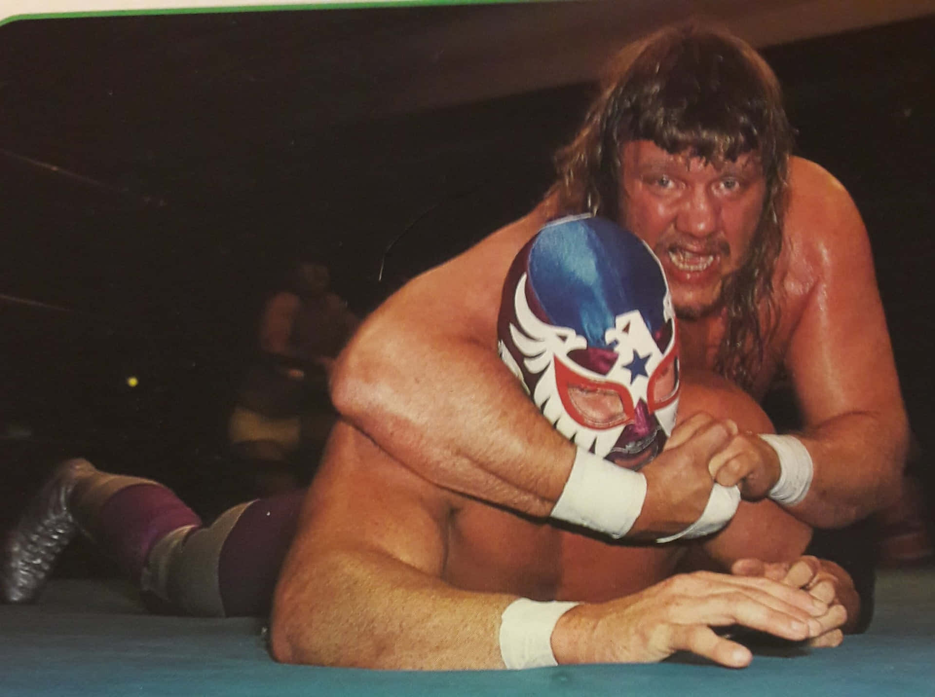 Legendary American Wrestler Terry Gordy in an intense match with a masked opponent. Wallpaper