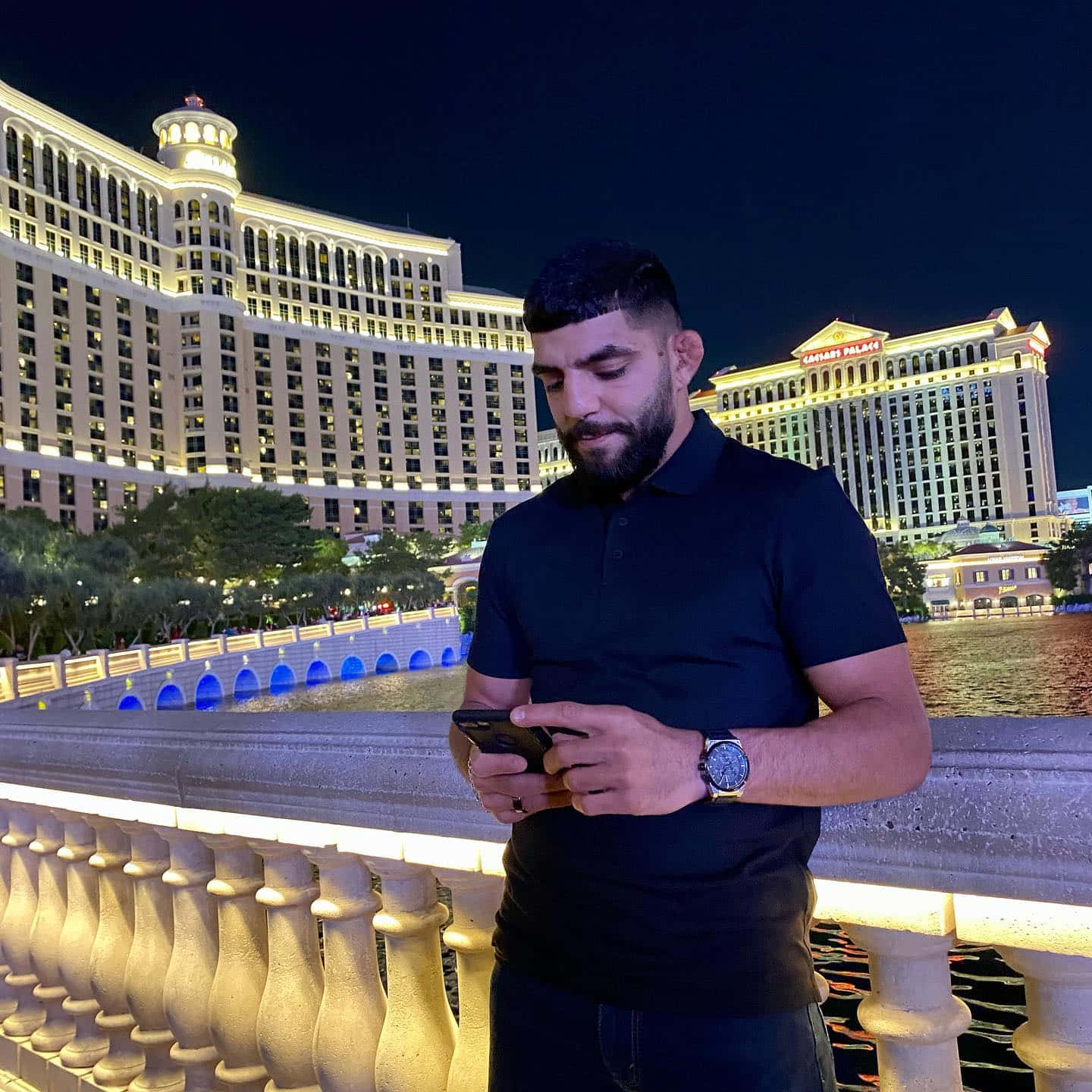 Amir Albazi Using Phone In Las Vegas Wallpaper