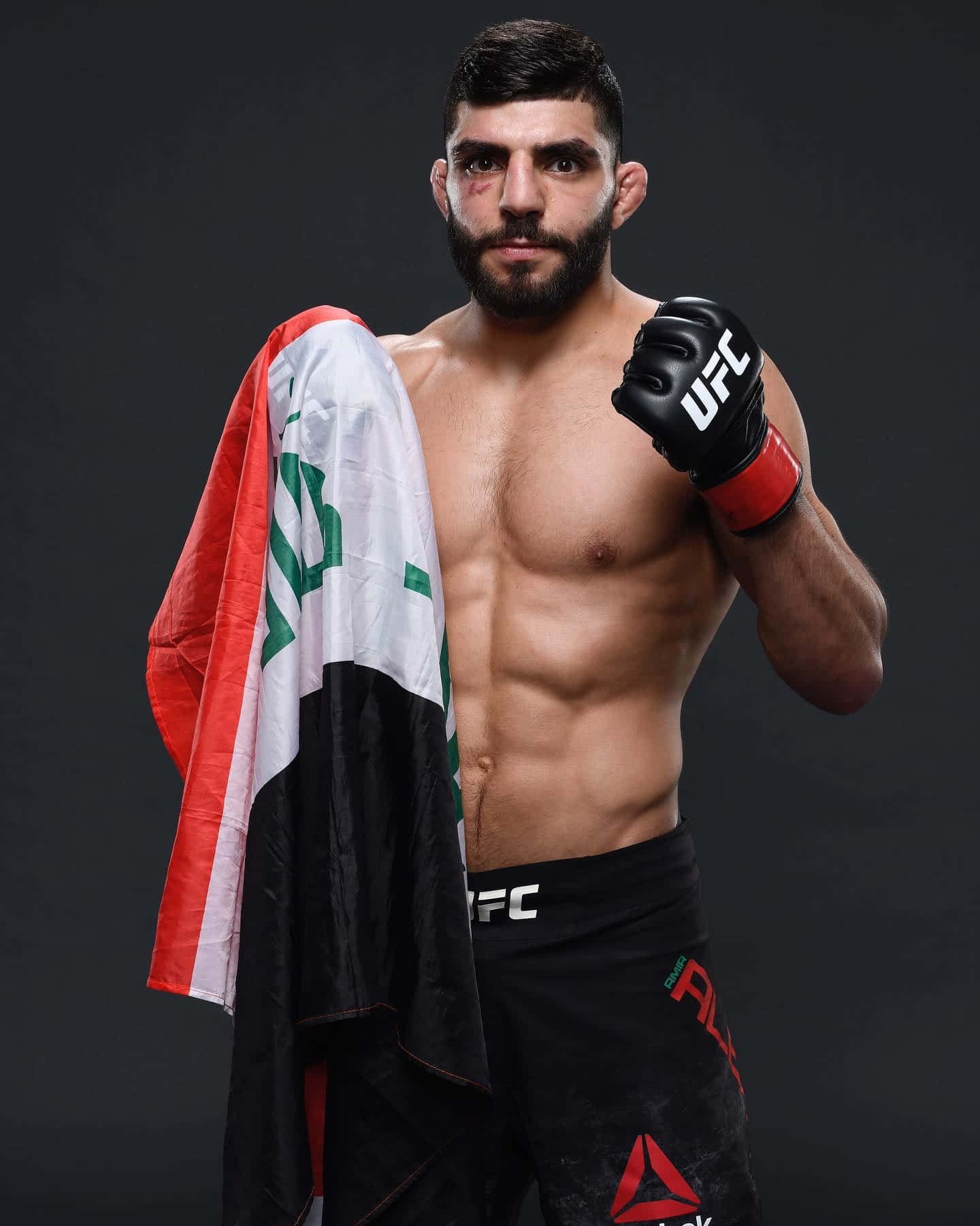 Amir Albazi Celebrating Victory with Fist Raised and Flag Wallpaper