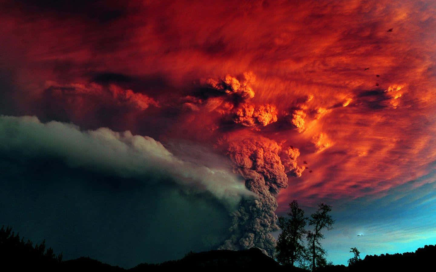 An Active Volcano Spewing Molten Lava Under The Starlit Night Sky Wallpaper