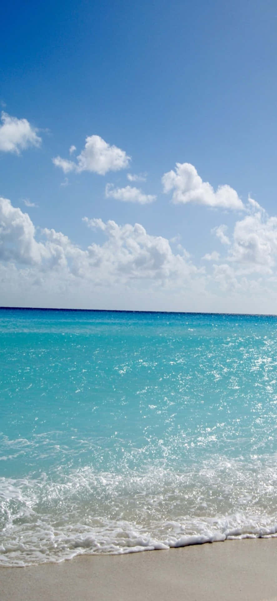 An Iphone X Showcasing A Stunning Beach Background.