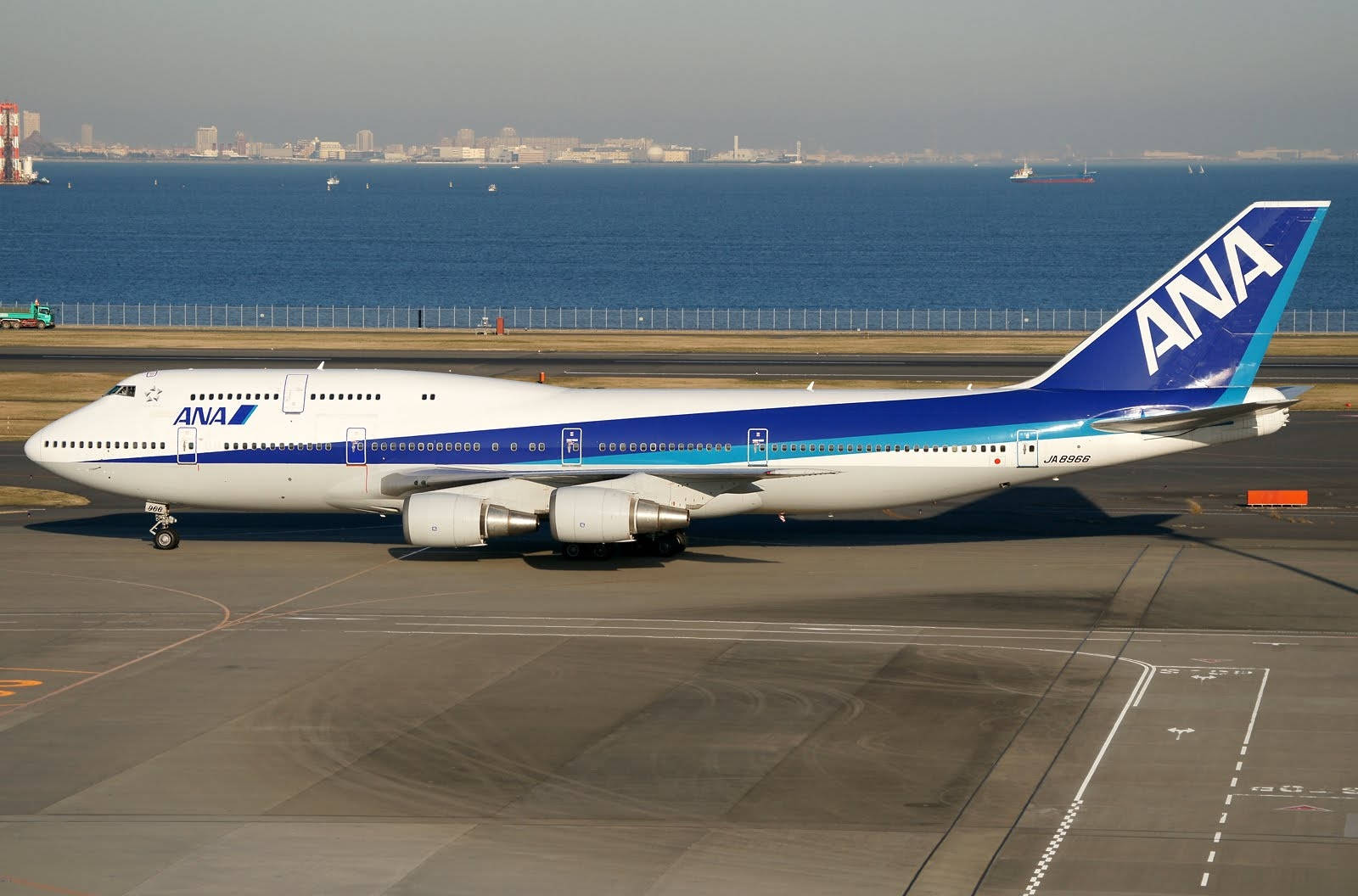 ANA Airplane Near A Blue Sea Wallpaper