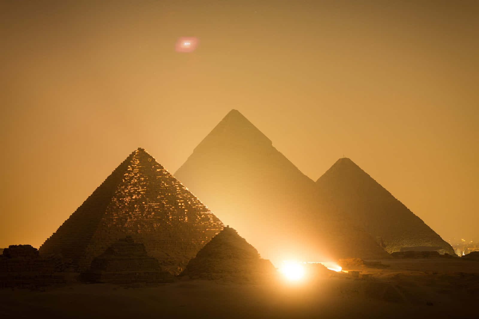 The Great Sphinx and Pyramids of Giza under a stunning sunset