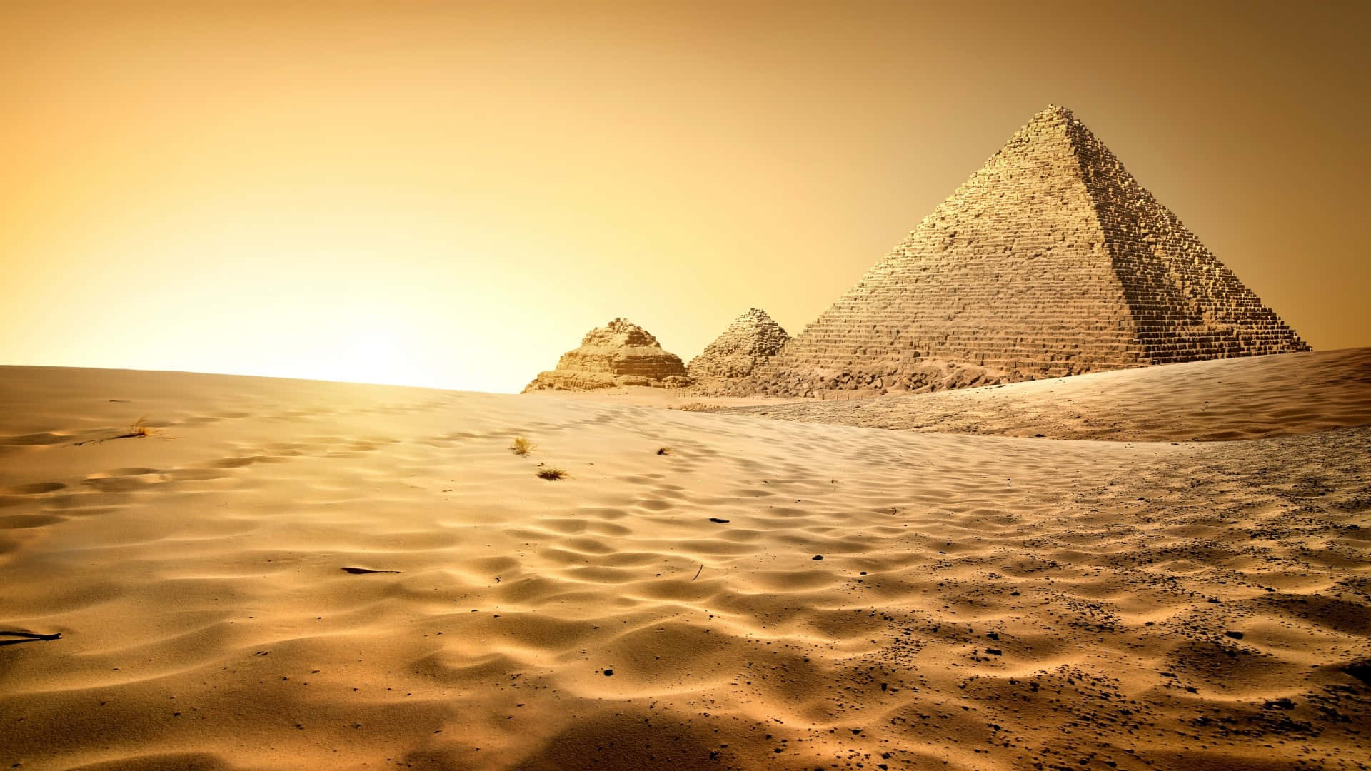 A Desert With Pyramids And Sand Wallpaper