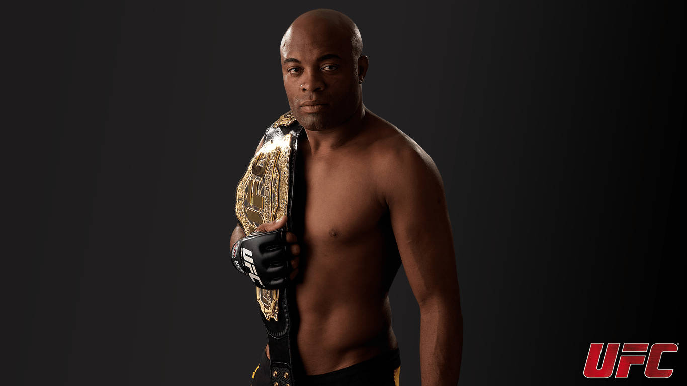 Anderson Silva, the legendary UFC fighter, holding his championship belt in triumph Wallpaper