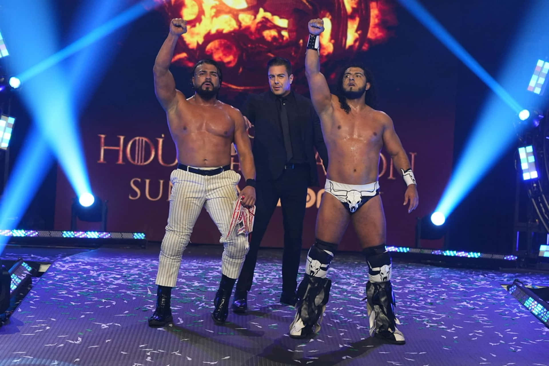 Andrade El Idolo posing with AEW wrestler in the ring Wallpaper