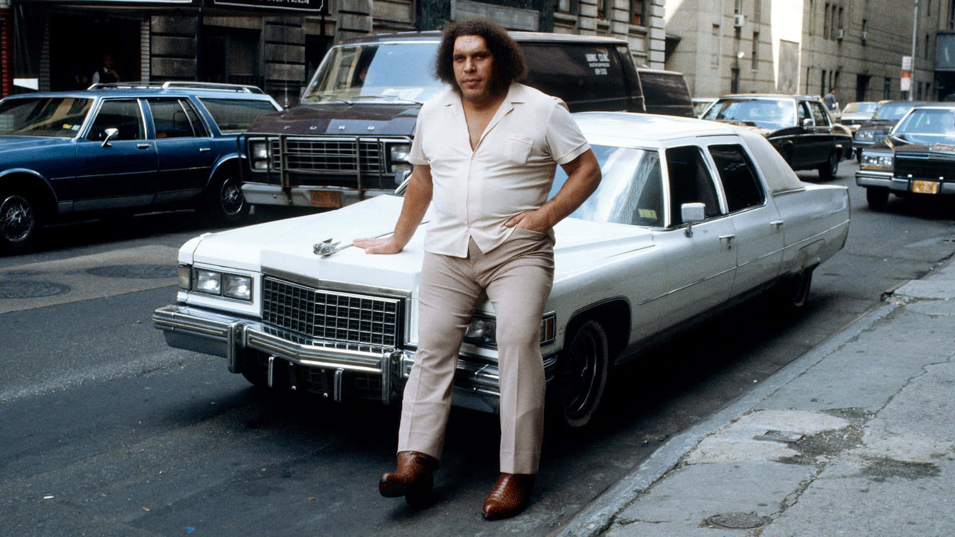 Andre The Giant Posing With A Car Wallpaper