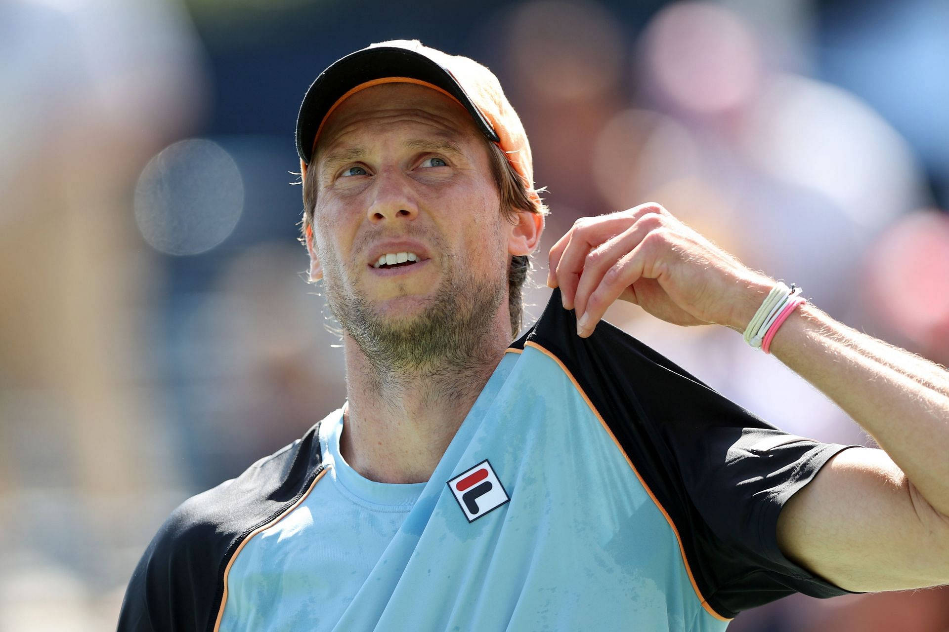 Caption: Champion Tennis Player Andreas Seppi, proudly holding his shirt Wallpaper