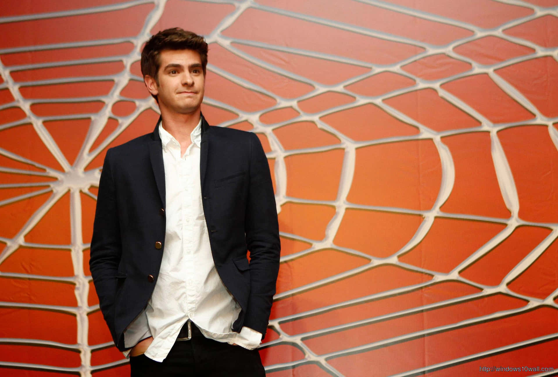 A Man In A Suit Standing In Front Of A Spider Web Wallpaper