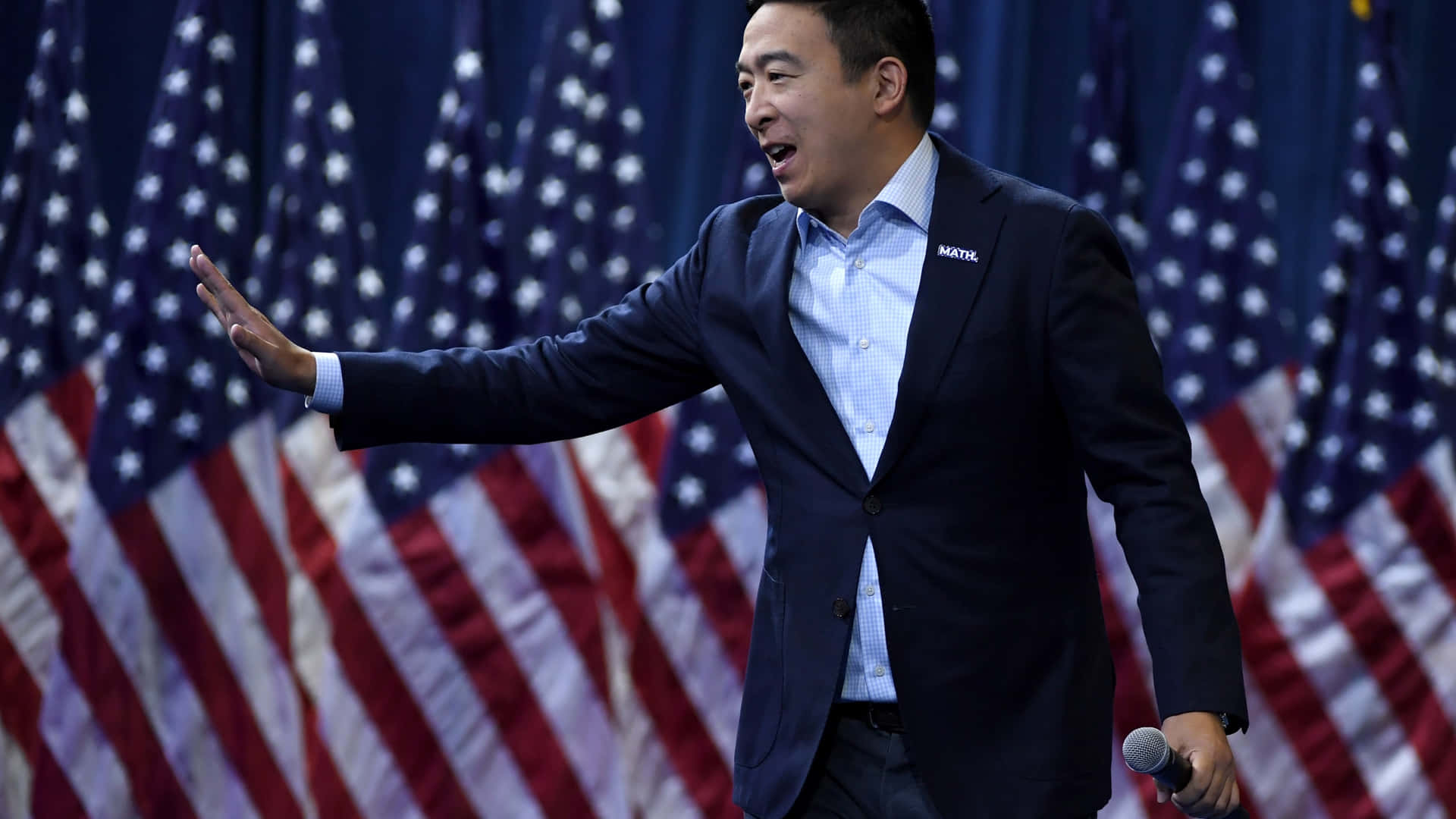 Andrew Yang Waving With American Flags Wallpaper