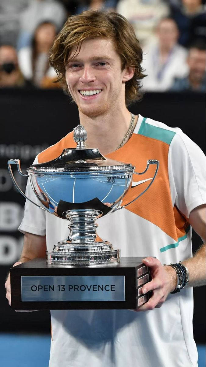 Andrey Rublev Holding A Cup Trophy Wallpaper