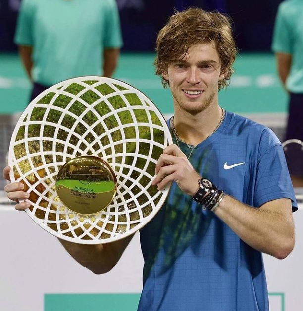 Andrey Rublev Triumphantly Holding Championship Trophy Wallpaper