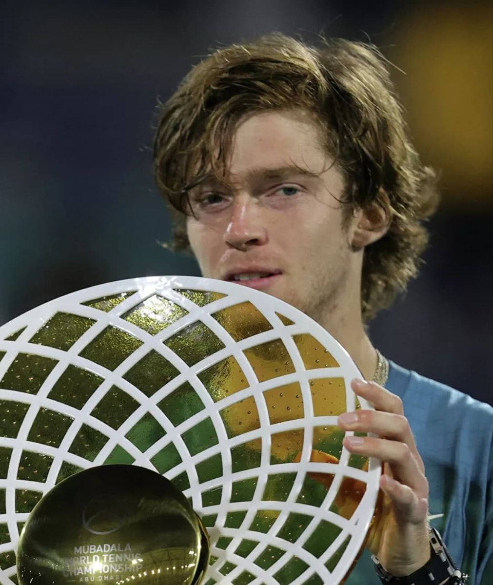 Victorious Moment: Andrey Rublev Holding the Tennis Championship Trophy Wallpaper