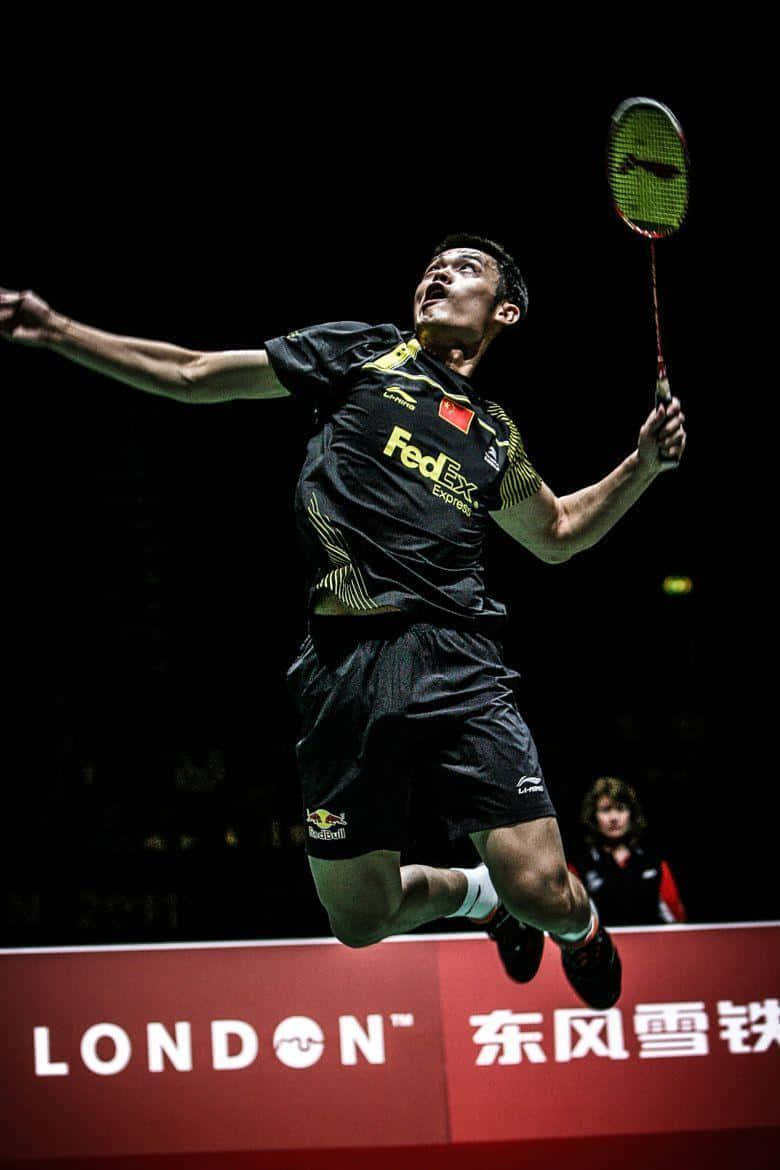 A Man In The Air With A Badminton Racket