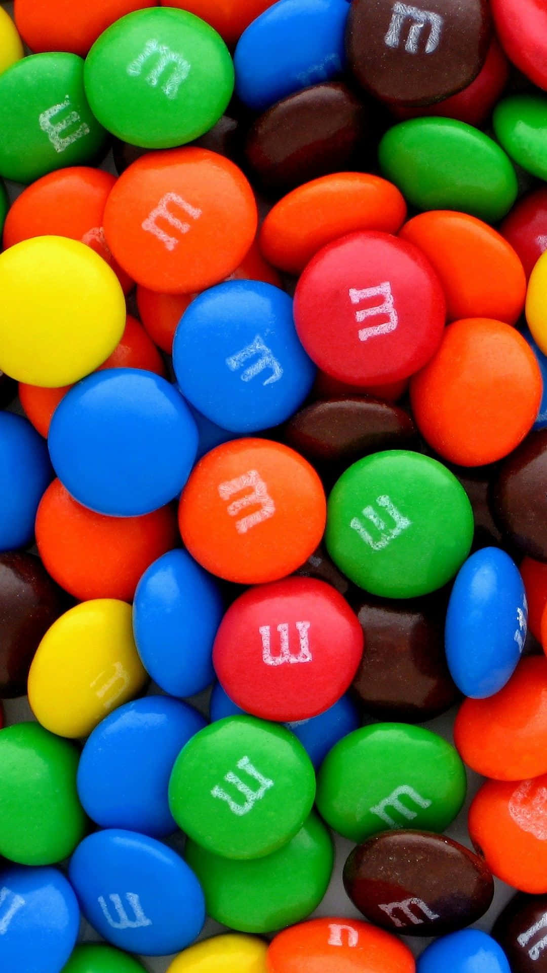 Farverige M&M'er på Android-fødevarebaggrund