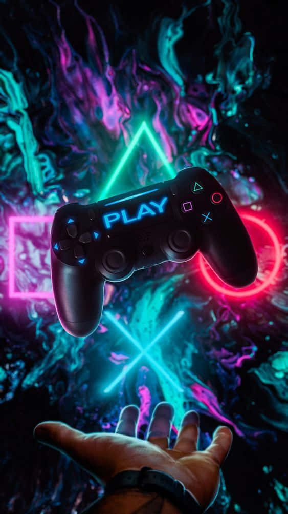 Eineperson Hält Einen Playstation-controller Vor Einem Neonfarbenen Hintergrund.