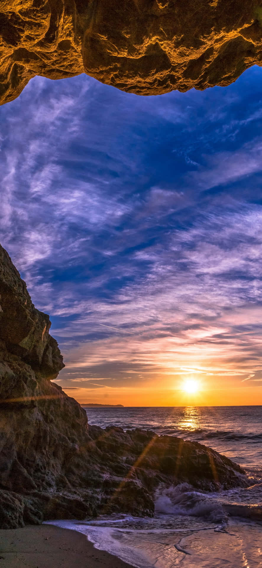 Strandhöhlemit Sonnenuntergang Android Malibu Hintergrund