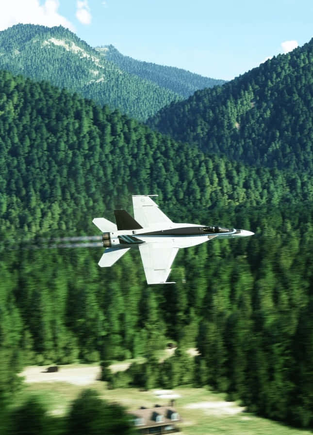 A Jet Flying Over A Forest With Trees