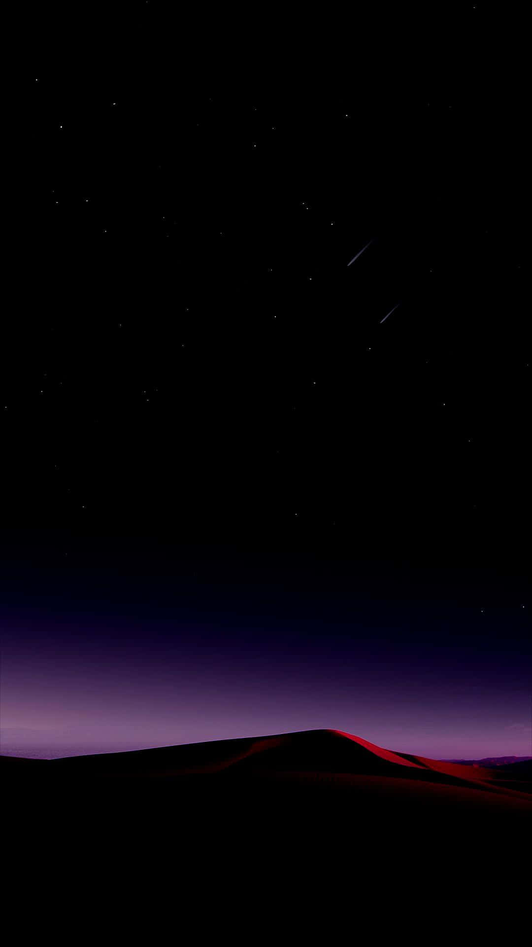 A Night Sky With Stars And A Hill