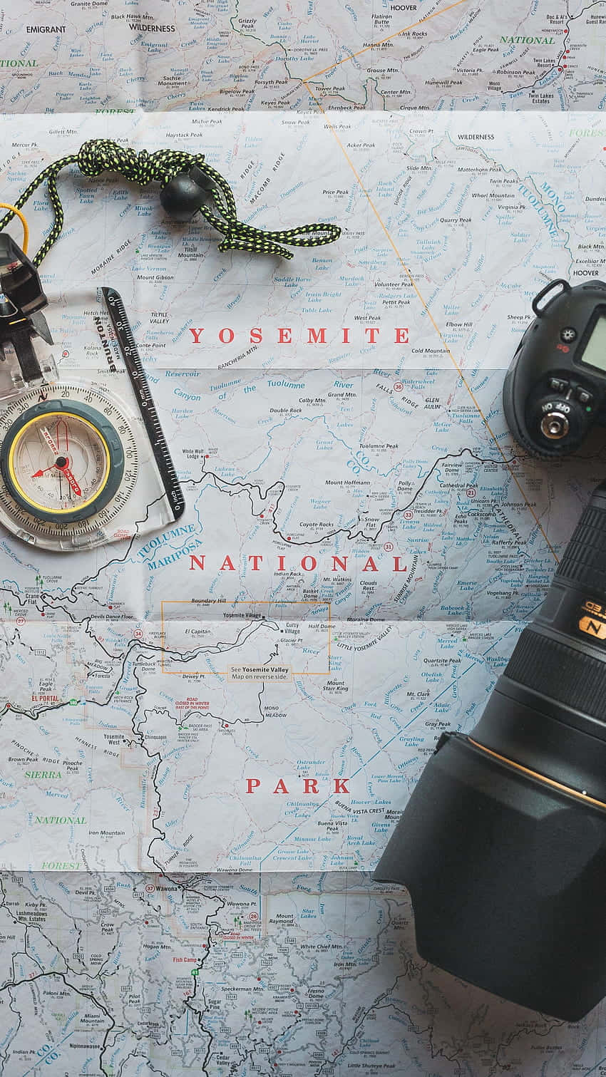 A Camera And A Compass On A Map