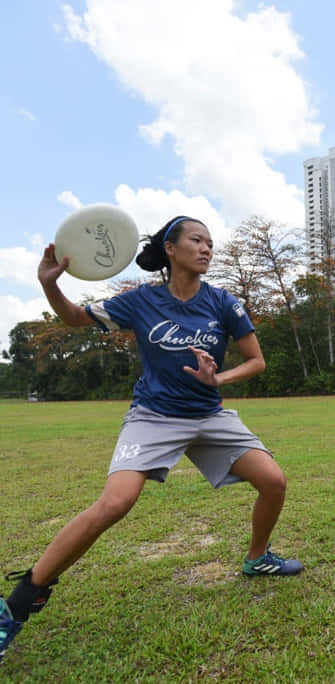 Asian Female Athlete In Blue Android Ultimate Frisbee Background