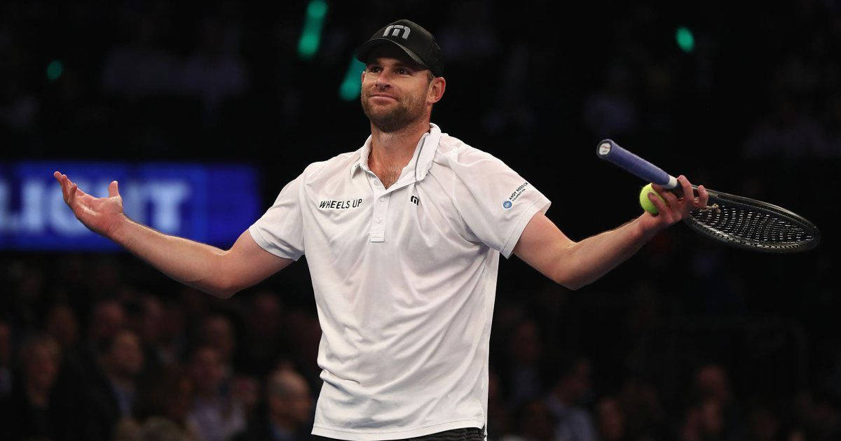 Energetic Andy Roddick Celebrating Victory on the Tennis Court Wallpaper