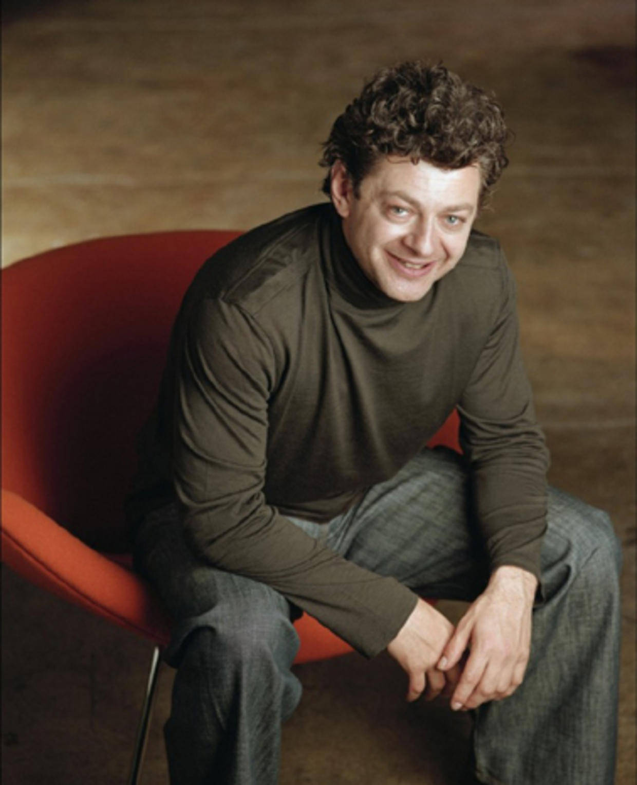 Andy Serkis In Red Chair Wallpaper