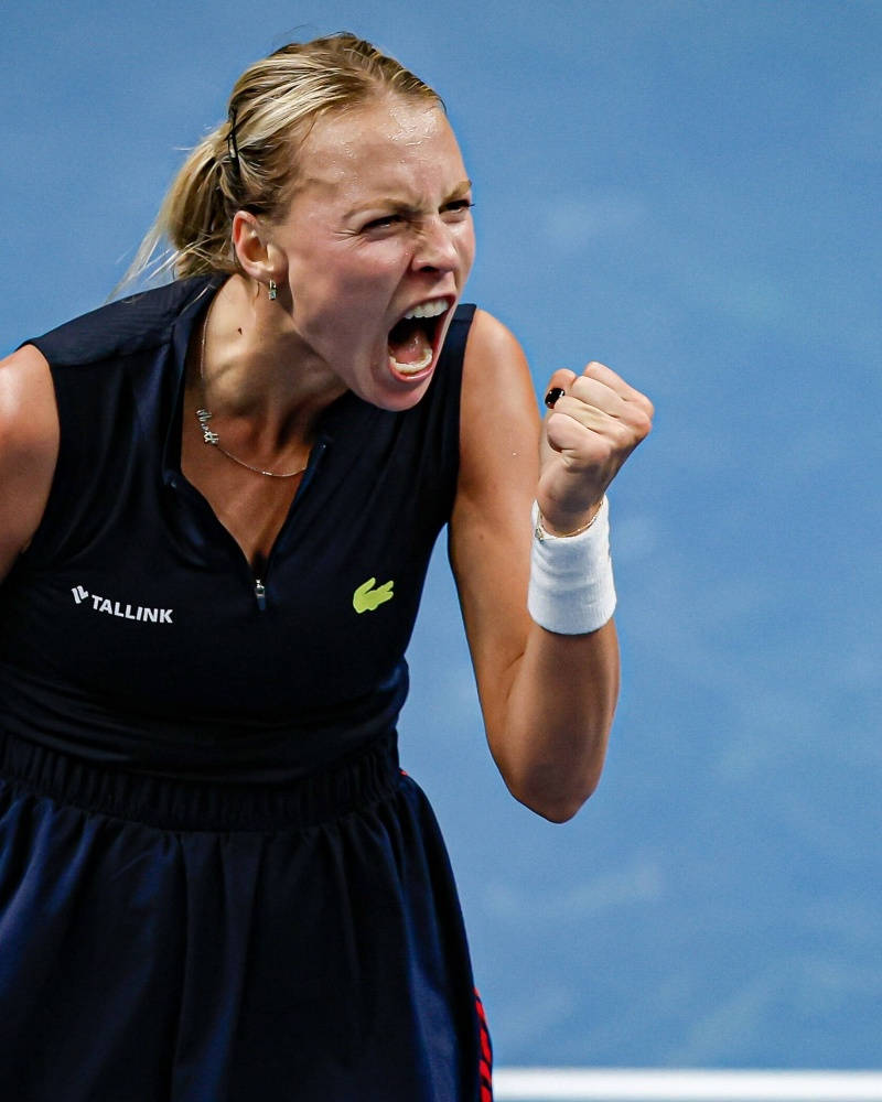 Caption: Anett Kontaveit Celebrating Victory with a Fist Pump Wallpaper