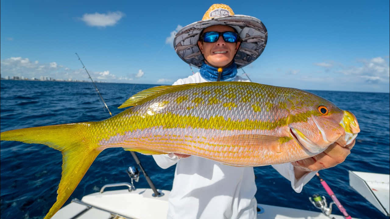 Anglerwith Yellowtail Snapper Catch Wallpaper