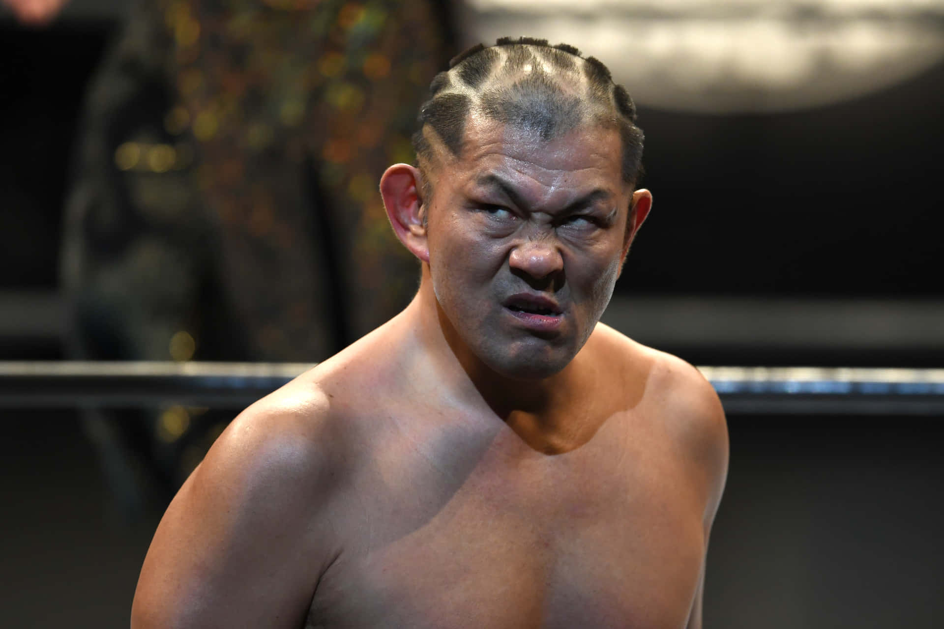 Minoru Suzuki showcasing his iconic angry expression in the ring Wallpaper
