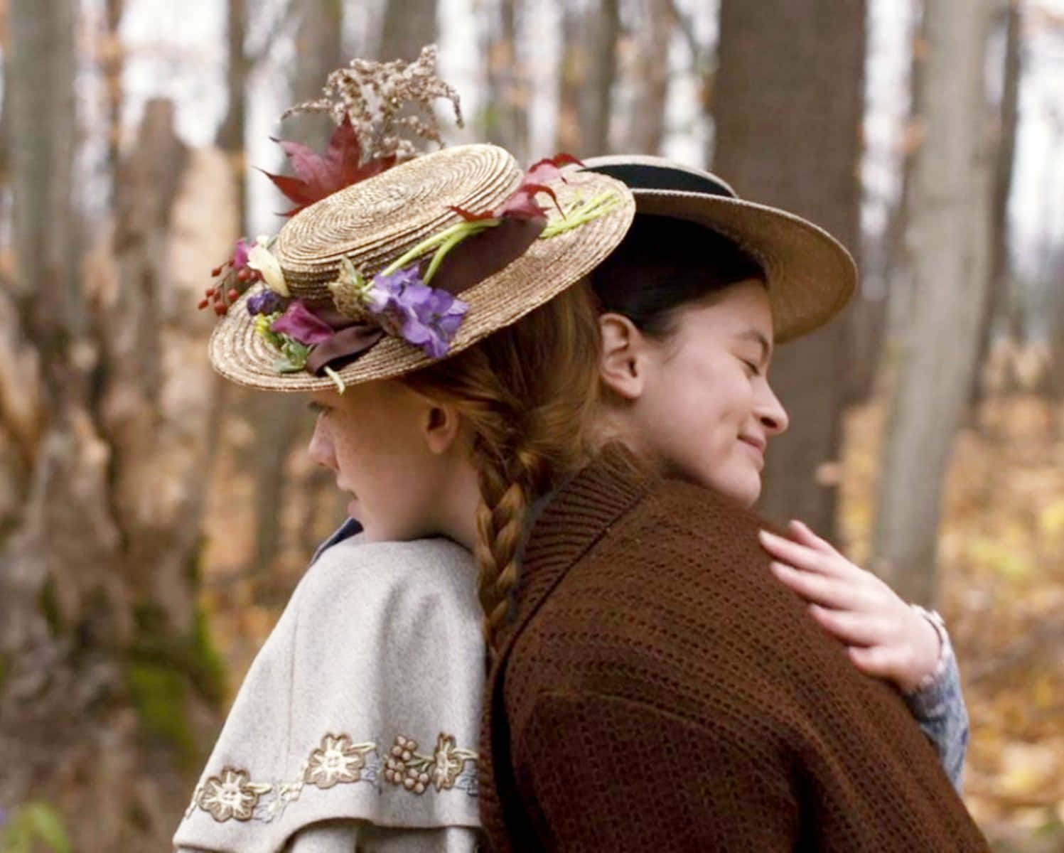 Two Girls In Hats Hugging In The Woods