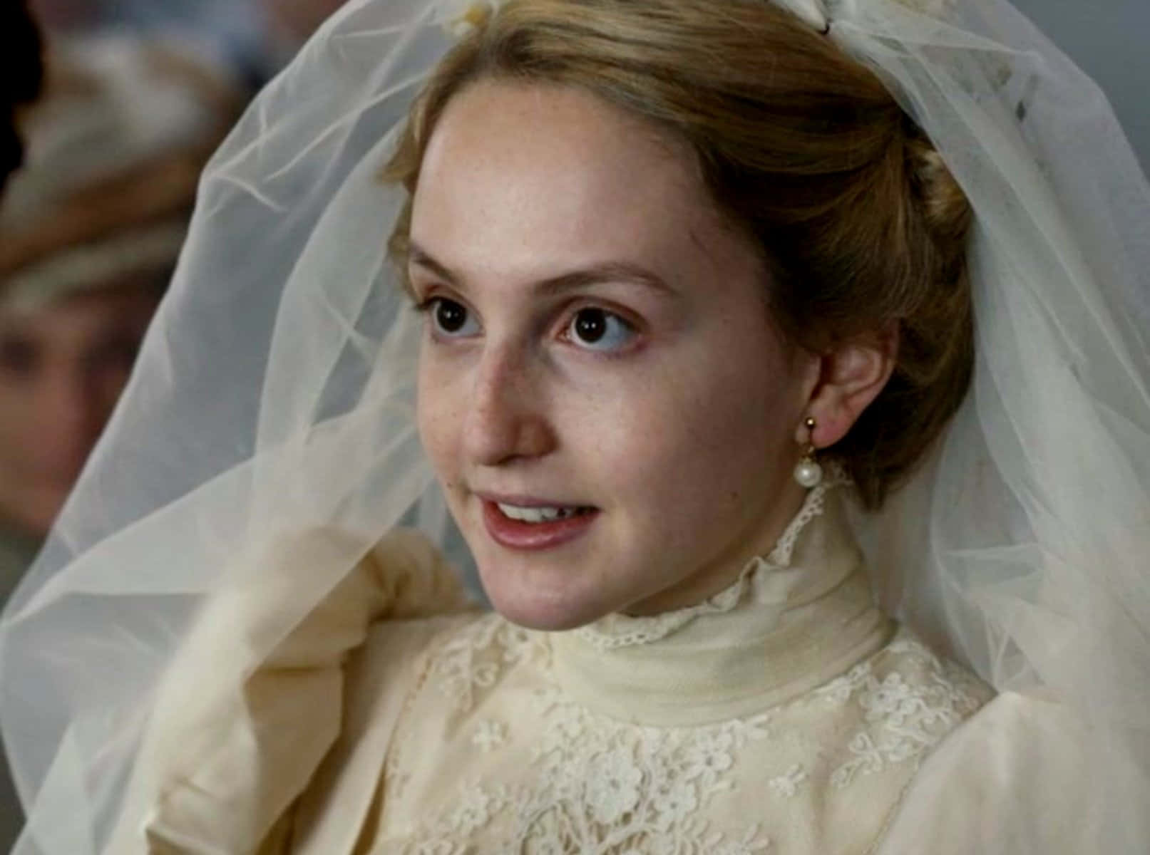 A Woman In A Wedding Dress Is Wearing A Veil