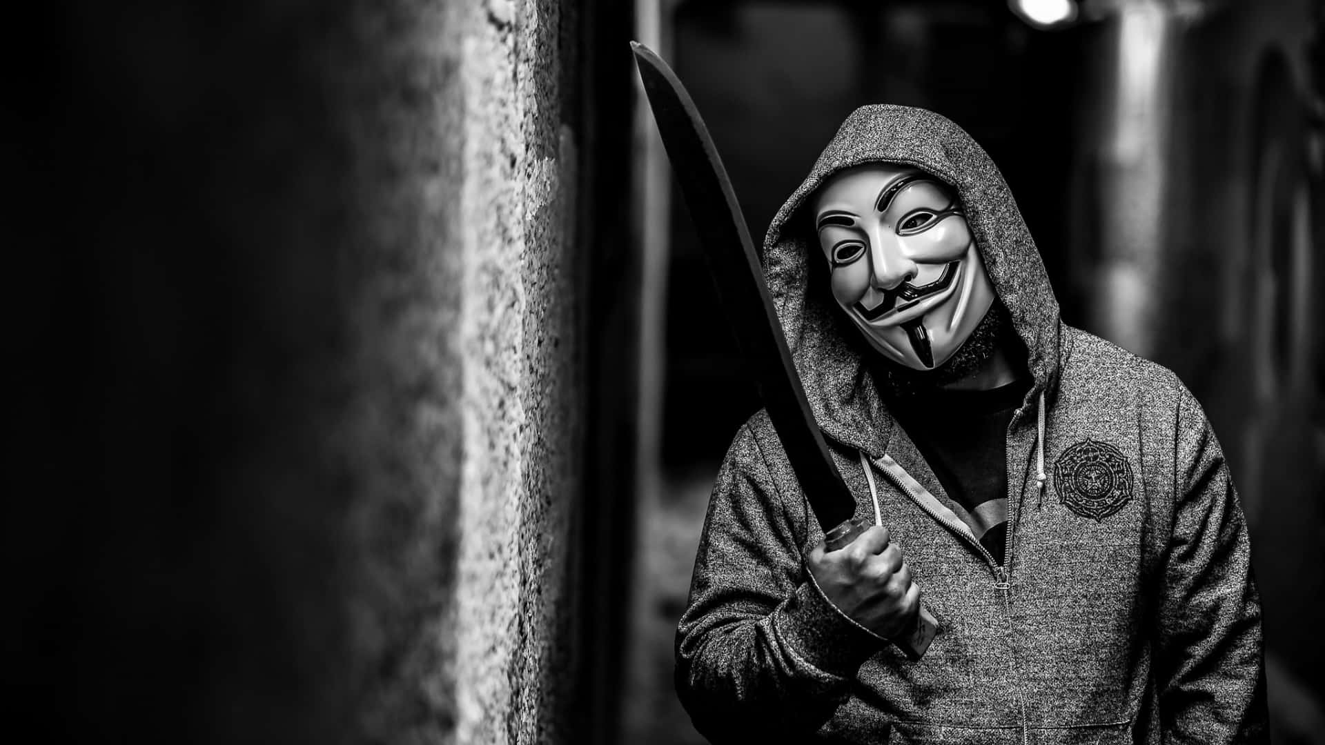 A Man In A Mask Holding A Knife Wallpaper