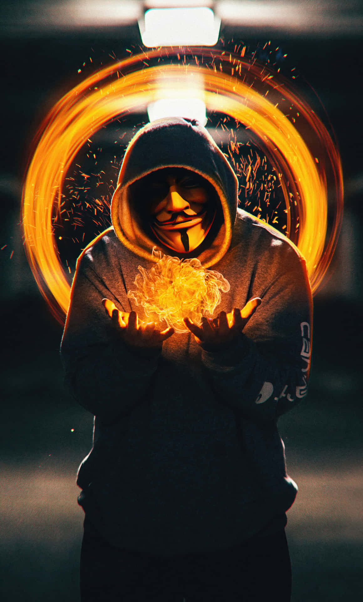 A Man In A Hoodie Holding A Fire Wallpaper