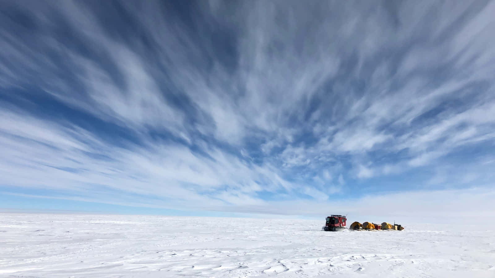 Antarctic Expedition Under Dramatic Skies Wallpaper