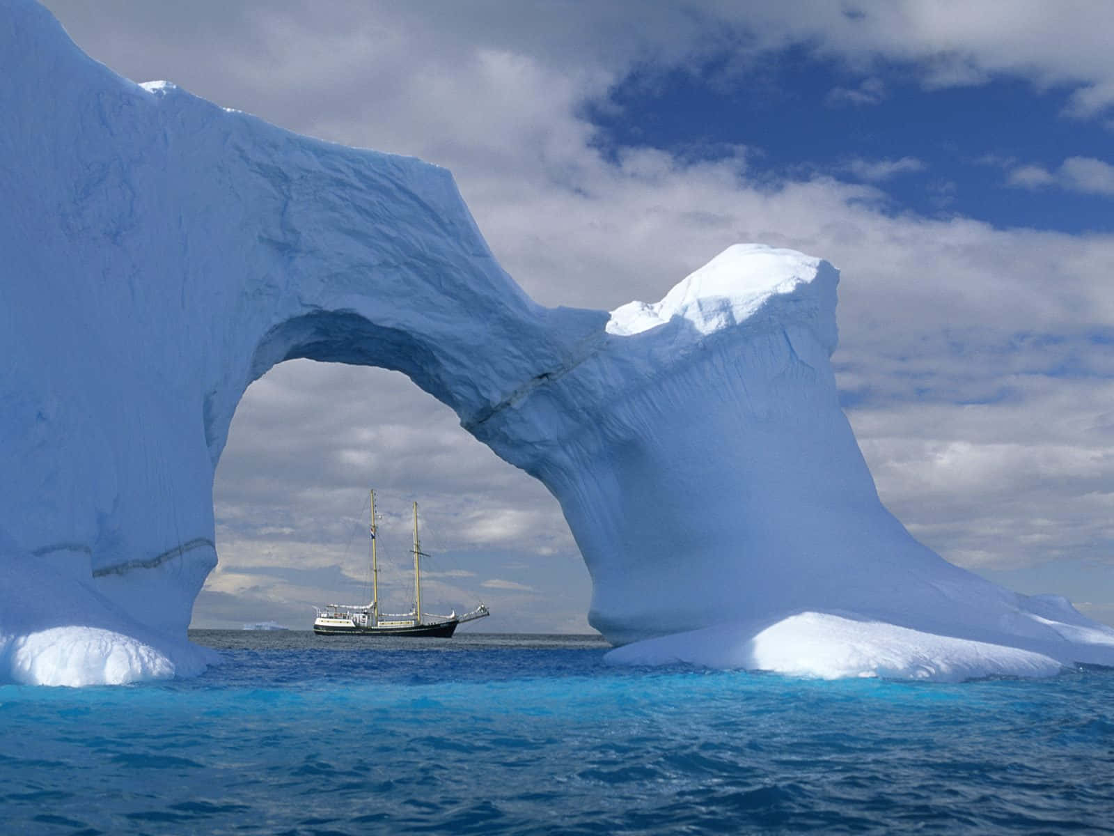 A Sailboat Is In The Middle Of An Iceberg