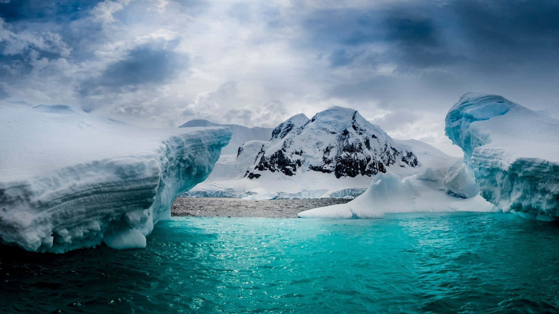 Majestic Mountains Overlooking Icebergs in Antarctica