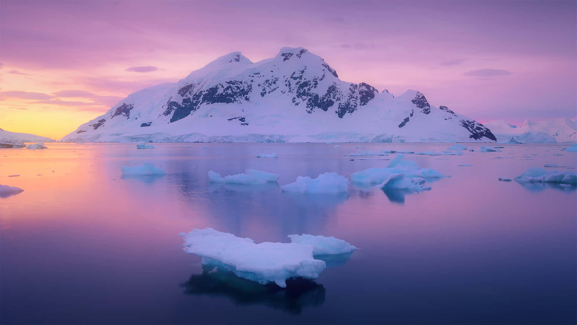 A Sunset With Icebergs And Icebergs In The Water