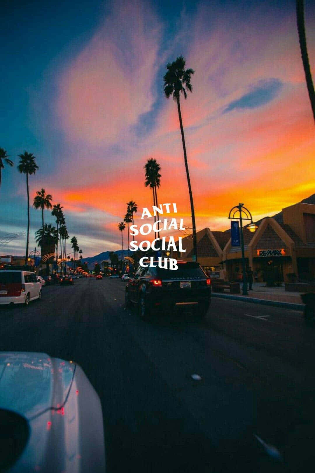 Byvandsse solnedgang og Anti Social Club iPhone Tapet Wallpaper