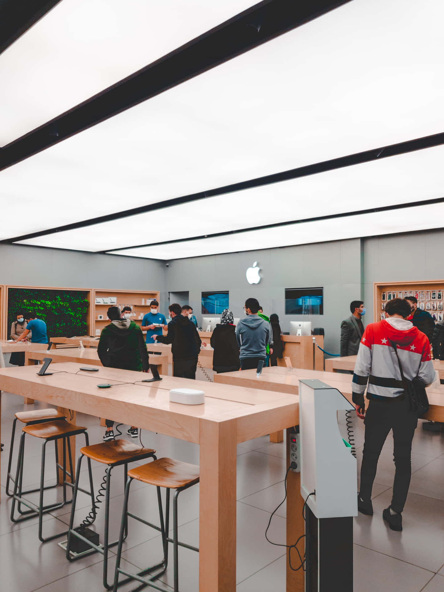 Apple Store Interiorwith Customersand Products Wallpaper