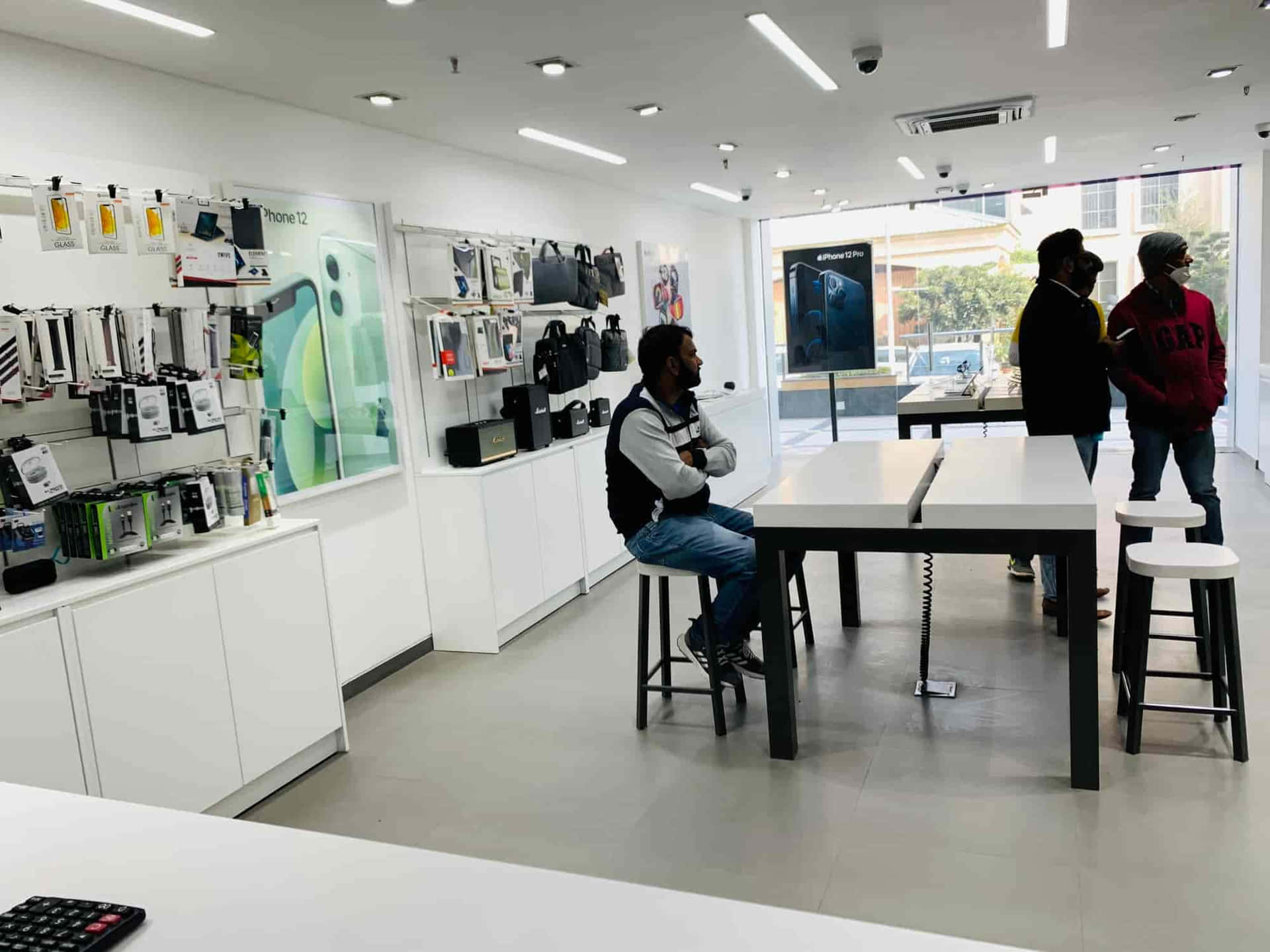 Apple Store Interiorwith Customersand Products Wallpaper