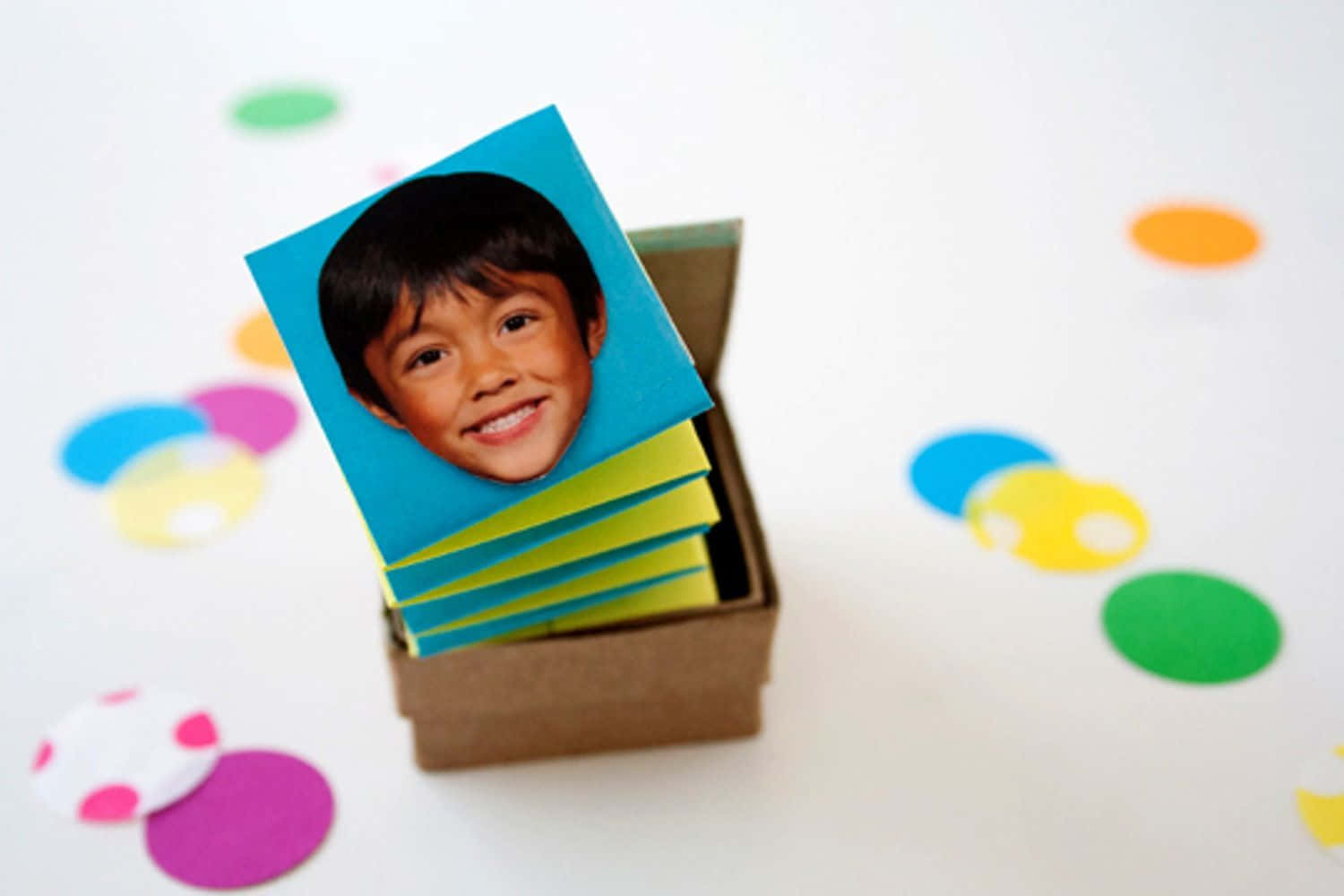 A Box Of Colorful Photo Cards With Confetti