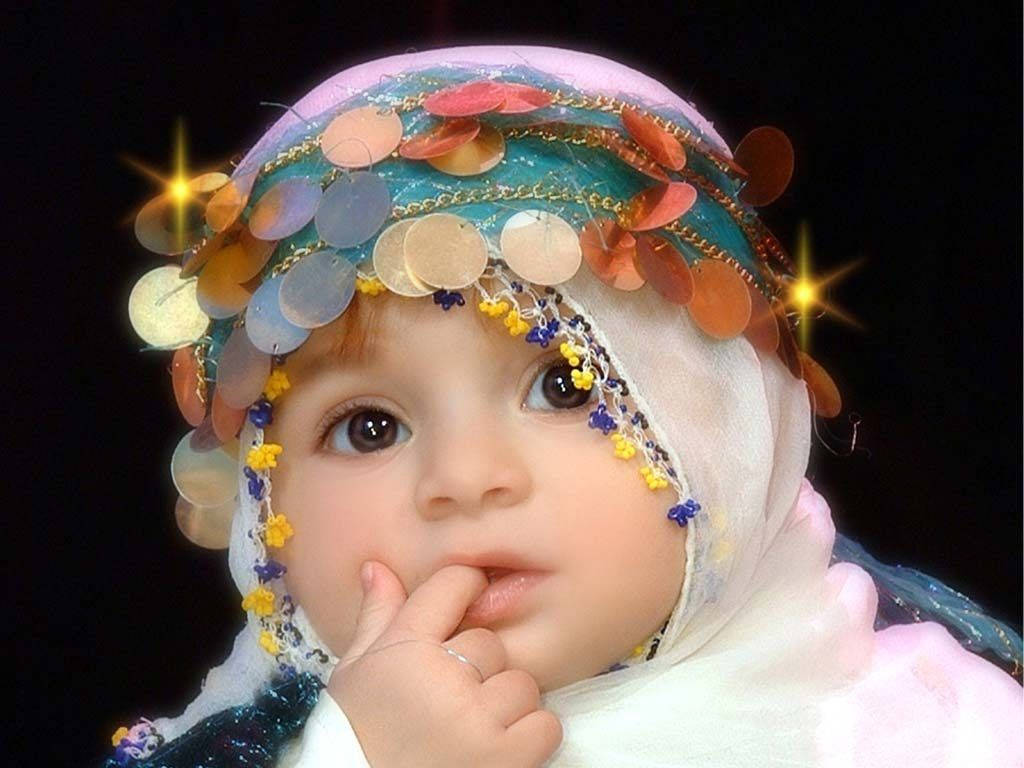 Image  A young Arab baby girl with lush hair and a bow headband Wallpaper
